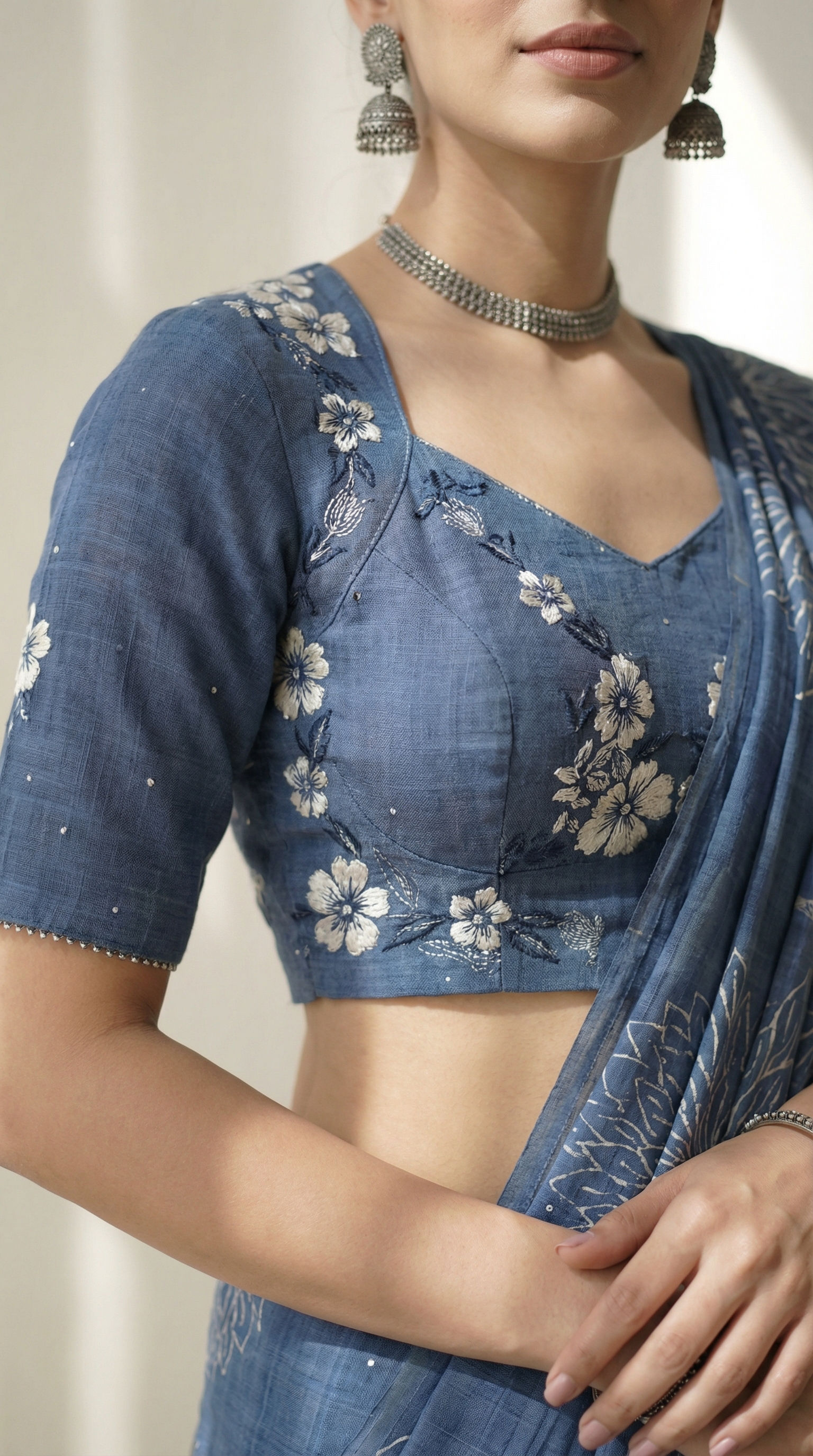 AI-generated close-up product visual of a blue floral-embroidered blouse