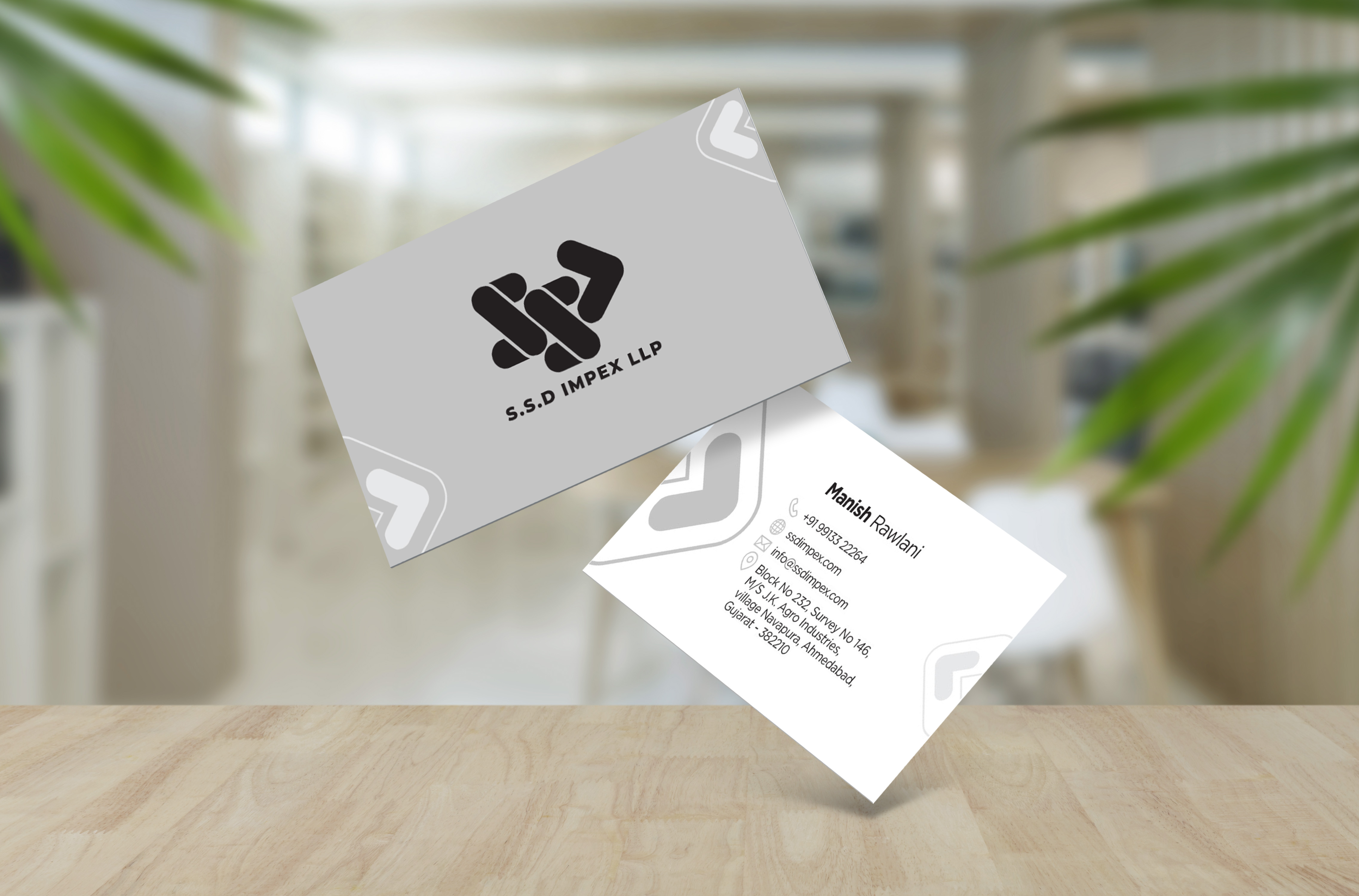 Business card mockup design for S&D Infra LLP on a wooden desk
